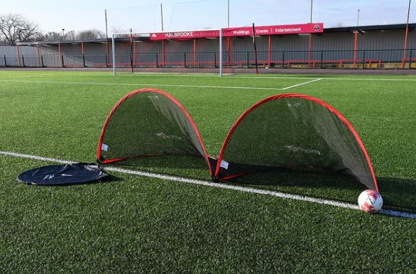 Precision pop up goal set on artificial turf with ball and carry bag, ideal for small-sided matches.
